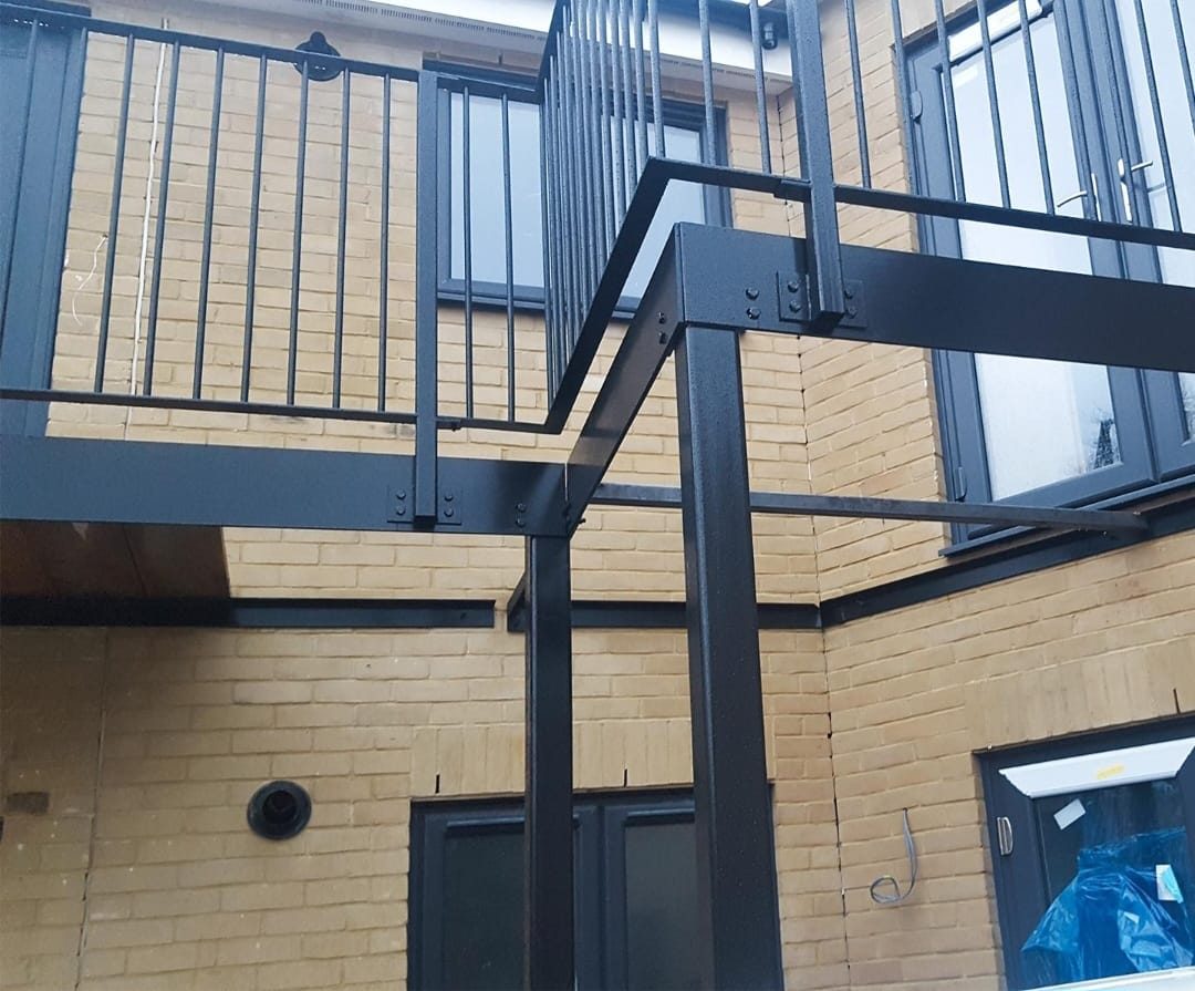 Black steel balcony with vertical-bar balustrade on a new-build home